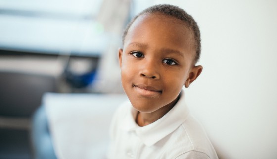 Boy Smiling in Exam Room.