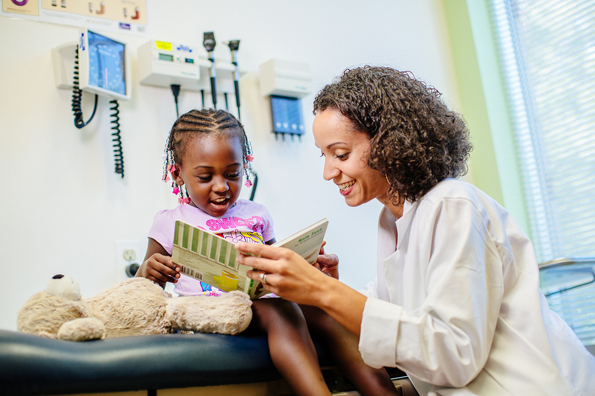 Provider and a Little Girl with a Book.