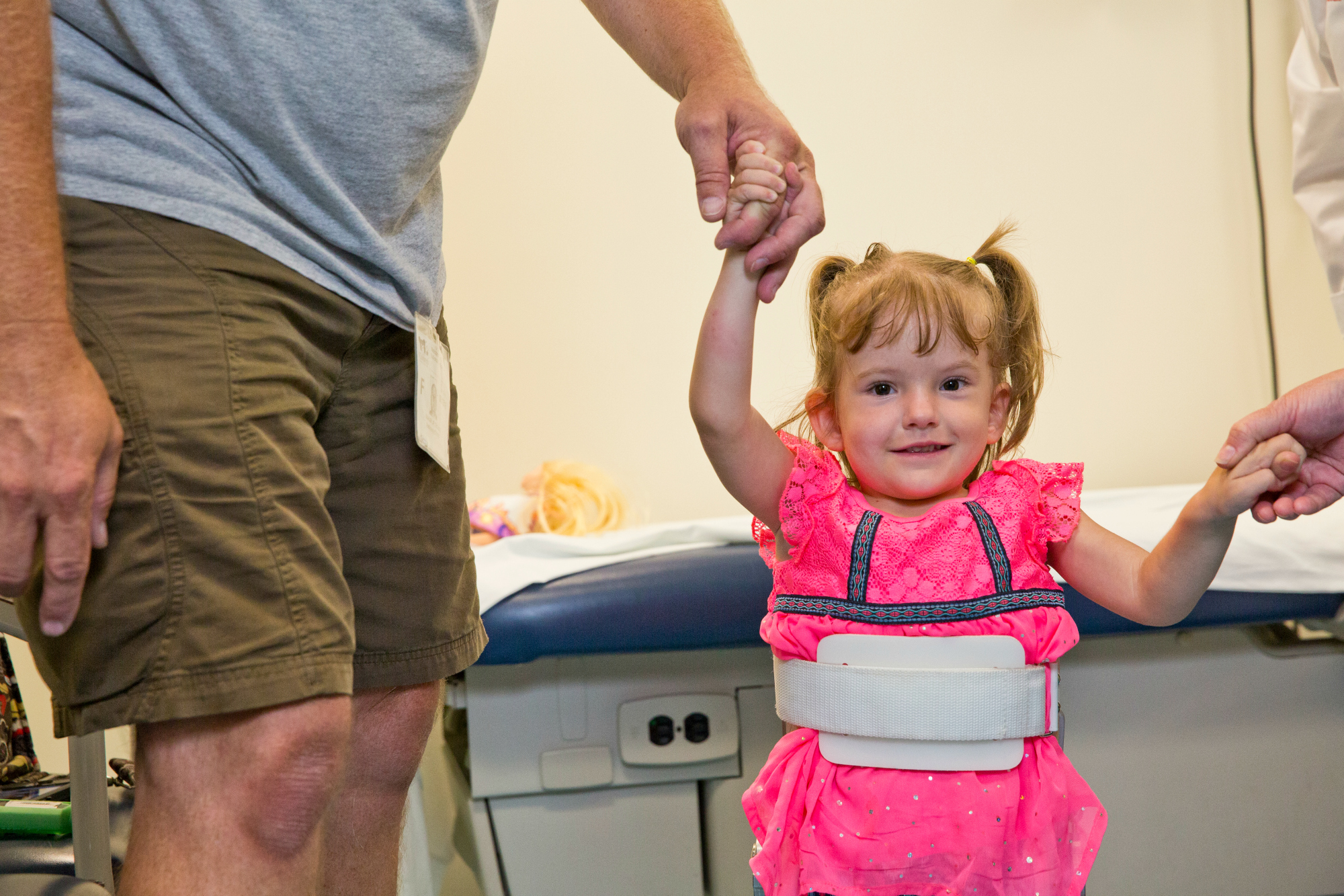Girl in wheelchair speaks with medical professional